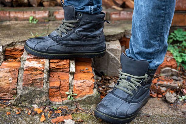 istock A pair of durable men's boots, legs close-up. 1486721785
