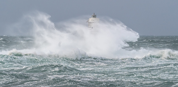 This image was taken during winter 2023 when the Storm arrived on the west coast of Sardinia. The waves were more than 40m high. We can see a beautiful Mangiabarche lighthouse striked by a huge wave. it was in Calasetta, Mangiabarche lighthouse