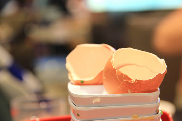 Eggshell in the tray and in the restaurant after cooking.Blurred background.