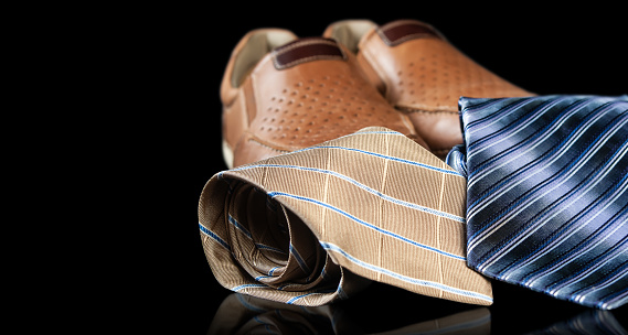 colorful ties and shoes  isolated on a black background