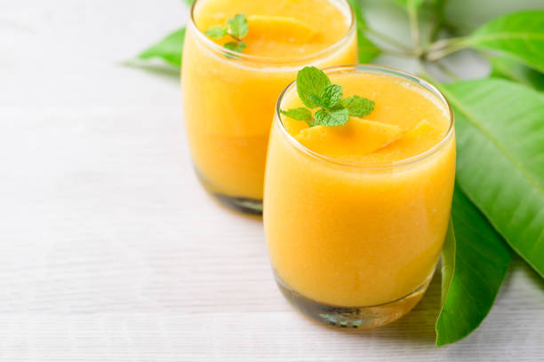 istock Fresh mango smoothie in glass, Cold drink in summer season 1486728691