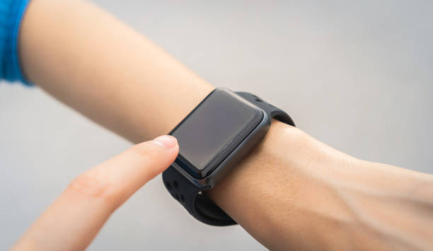 istock Woman wearing a smartwatch and touching to check on o'clock. 1486729476