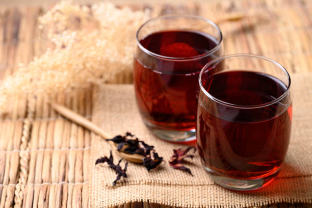 Roselle tea in glass with dried roselle, Herbal drink for reduction in blood pressure stock photo