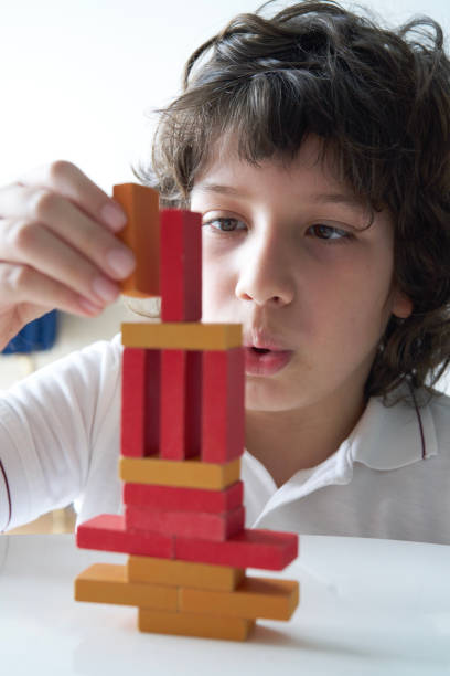 istock Cute Little Boy Playing with wooden block 1486731308