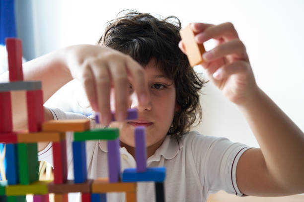 istock Cute Little Boy Playing with wooden block 1486731557