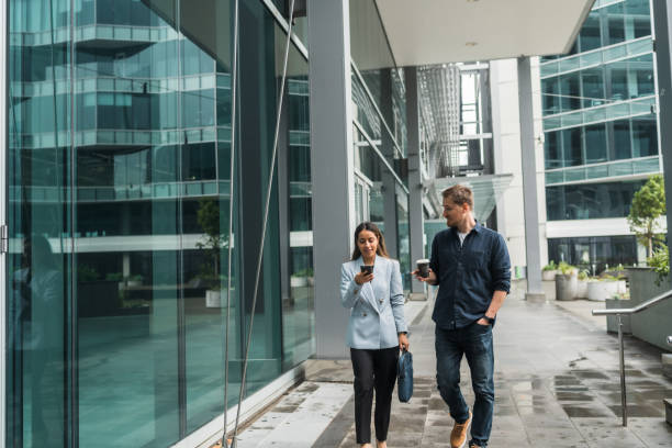 istock Two colleagues walking to the office. 1486733654