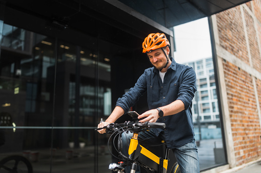 Business professional unlocking an electric bike using smart phone.