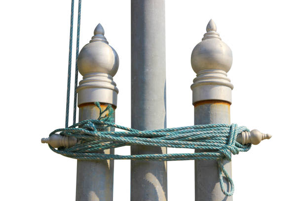 Several plastic ropes are wrapped around a large steel pole isolated on white background.