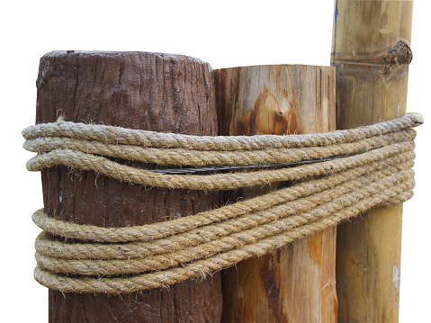 Rope with knot wrapped around a brown wooden post. isolated on white background.