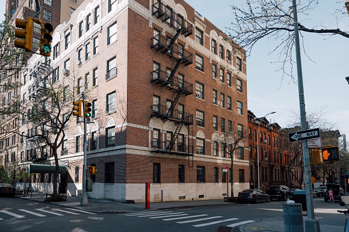 Close-up view of New York City style apartment buildings with emergency stairs along Mott Street in the Chinatown neighborhood of Manhattan NYC.