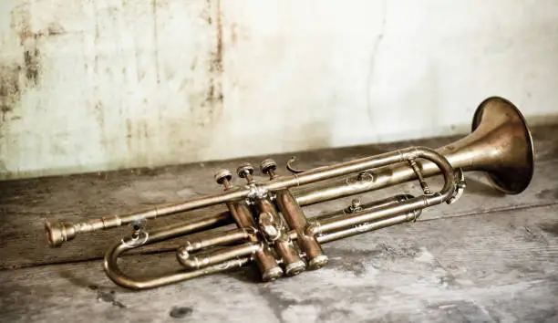 Photo of an antique Jazz trumpet on an old background of an old house