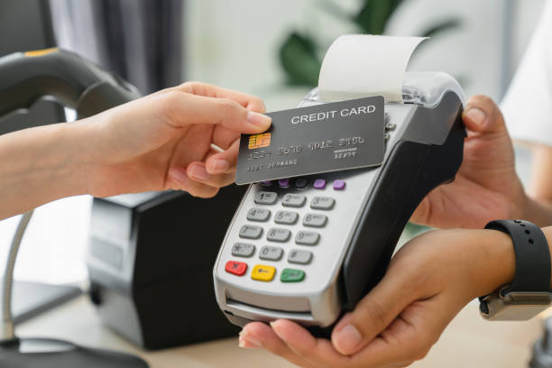 istock Customer using credit card for payment by NFC technology on card reader machine to owner at restaurant. 1486740174