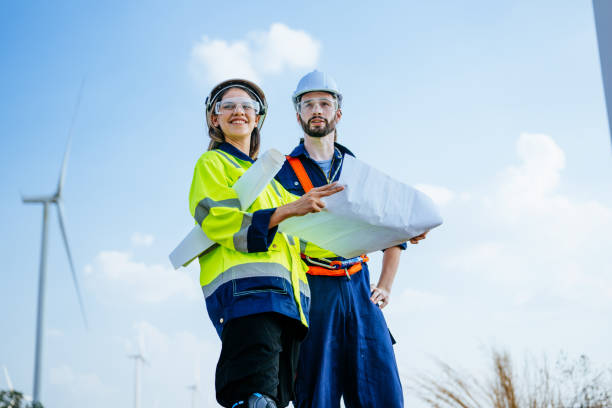 istock Professional engineers technicians working at wind turbine farm field 1486744155