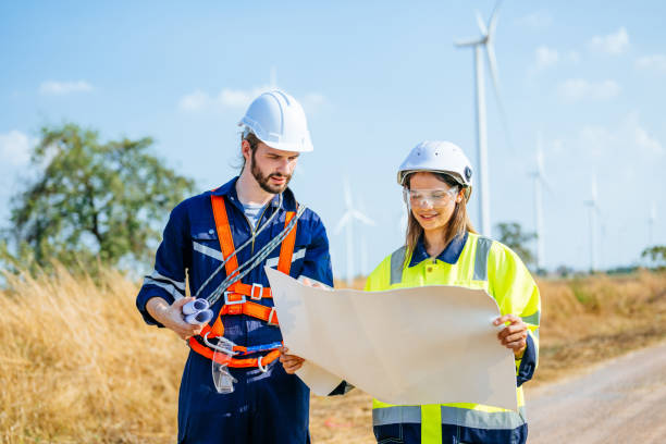 istock Professional engineers technicians working at wind turbine farm field 1486745258