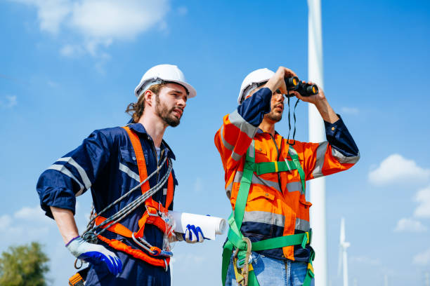 istock Professional engineers technicians working at wind turbine farm field 1486748024