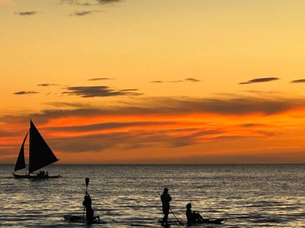 istock Sunset with kayak and sailing boat 1486748959