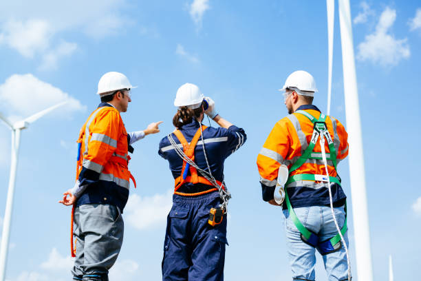 istock Professional engineers technicians working at wind turbine farm field 1486749189