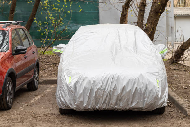istock car cover to protect from the sun and rain. machine in a protective case 1486749412