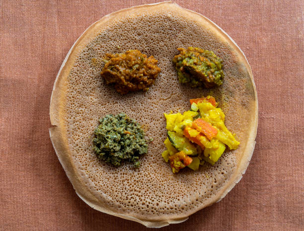 istock Injera with lentils and vegetables, sour fermented pancake-like flatbread which is a staple food of Ethiopia and Eritrea 1486751415