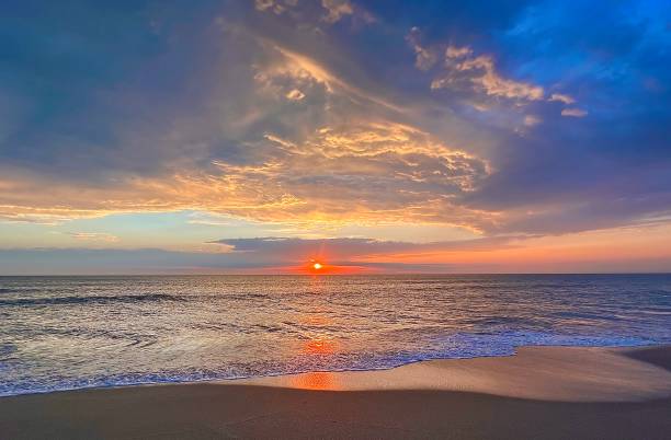istock Beautiful tropical multicolored sunrise at the beach 1486753490