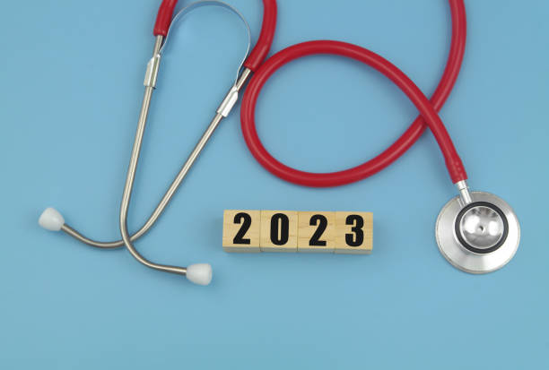 istock Red stethoscope and numbers  2023 on wooden cubes. 1486754459