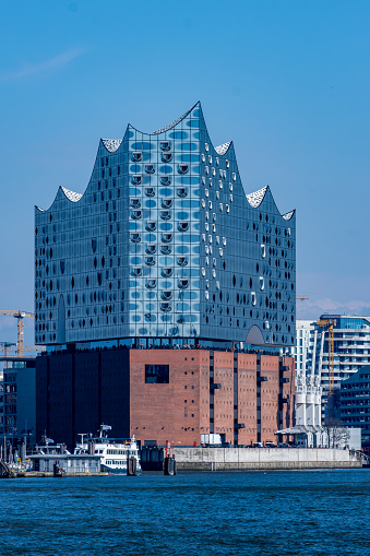 Hamburg, Germany - 04 17 2023: View of the Elbphilharmonie in the port of Hamburg from the Elbe.