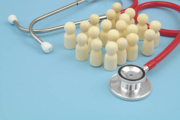istock Red stethoscope with  many people figures on blue background. 1486756930
