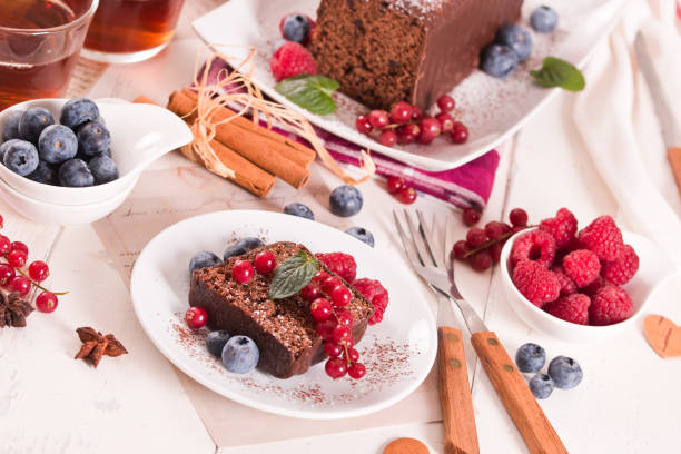 istock Chocolate sponge cake with fresh fruit on white dish. 1486756970