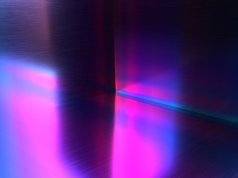 A metallic surface with a purple and pink light on it. 3d