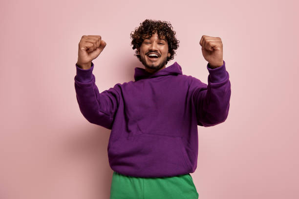 istock Excited young Indian man looking at camera and gesturing against pink background 1486758339