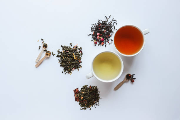 istock Herbal leaf dried tea and cups with drink, top view on white background 1486759265