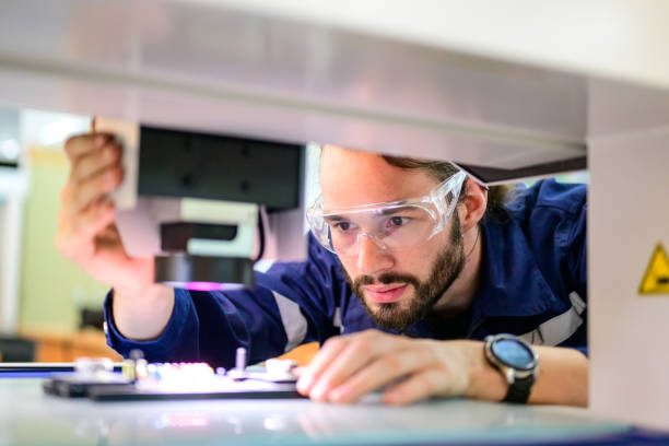 istock Professional technician checking part of automatic machine at factory 1486761248