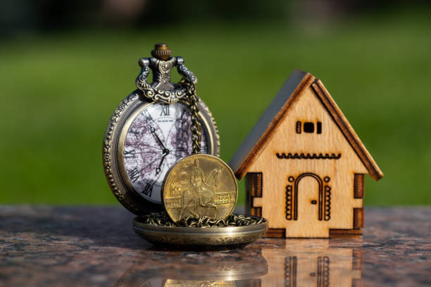 20 czk coin, miniature wooden house and antique pocket watch - czech culture currency wealth coin imagens e fotografias de stock