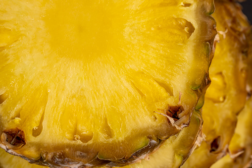 sliced pulp of peeled ripe pineapple , sweet delicious yellow pineapple cut into pieces