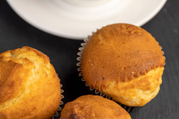 istock Soft and fresh fragrant wheat cupcake on a black stone 1486767212