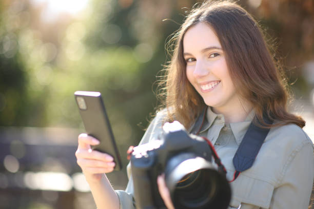 istock Happy photographer pairing phone with camera 1486769387