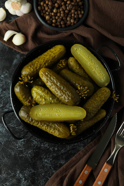 istock Fresh pickles and spices on black smokey table 1486770717