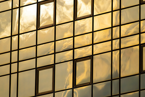 sunset reflection in the windows of the building. part of the building