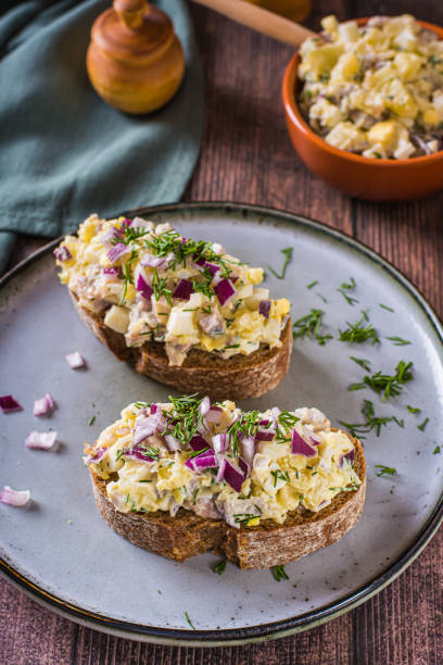 istock Bruschetta on rye bread with swedish salad on a plate on the table vertical view 1486772977