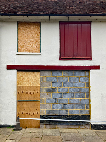 Townhouse boarded up with breeze blocks and wood