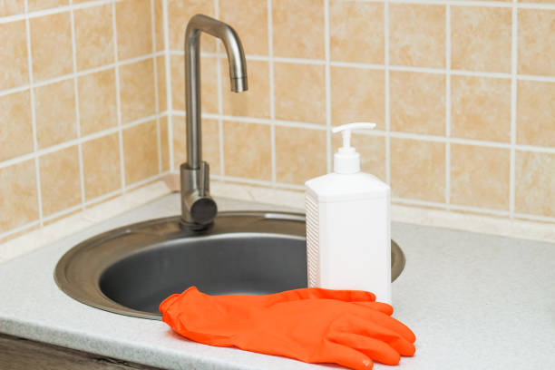 istock Kitchen sink with faucet and gloves for cleaning and detergent 1486778949