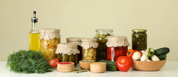 istock Jars of pickled vegetables and ingredients on white table 1486782841