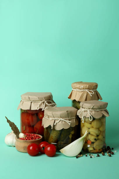 istock Jars of pickled vegetables on mint background 1486783324