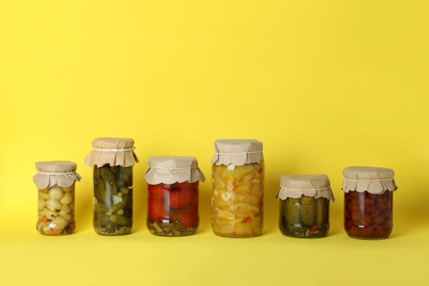 istock Jars of pickled vegetables on yellow background 1486783403