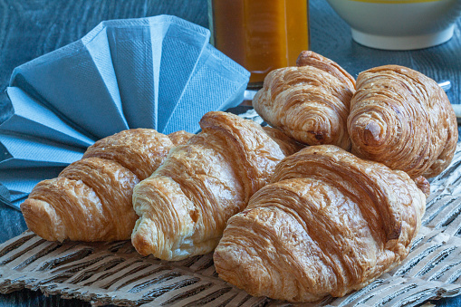 Croissants on table with bowl, napkin, jam, for breakfast
