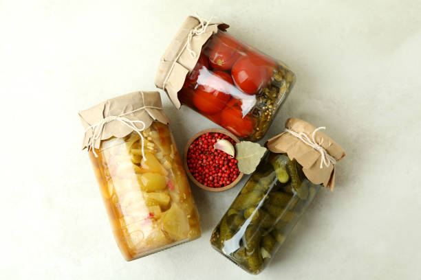 istock Jars of pickled vegetables on white textured background 1486784304