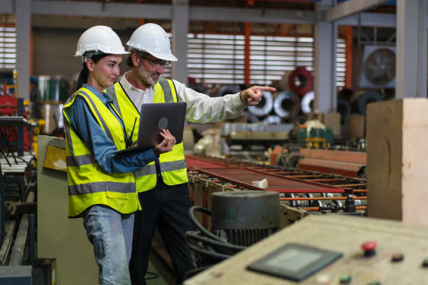 istock The project manager and engineers are inspecting workpieces and checking standards and safety for products and safety in the factory. Technician and Female Worker Talking on a Meeting in a Factory. 1486788041