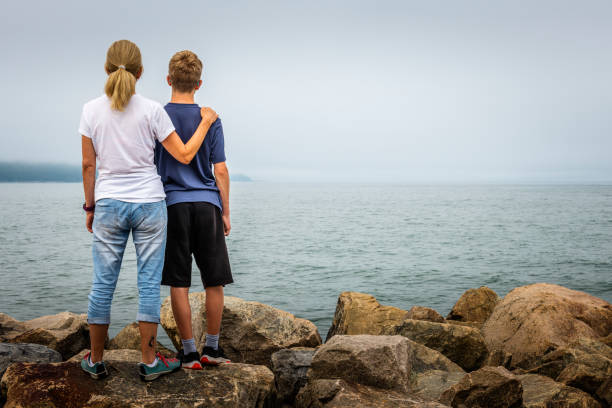 mother and son looking over St. Lawrence River in Canada