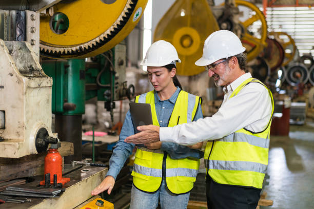 istock The project manager and engineers are inspecting workpieces and checking standards and safety for products and safety in the factory. Technician and Female Worker Talking on a Meeting in a Factory. 1486788880