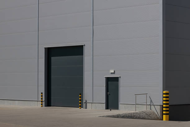 istock Grey roller shutter entrance for industrial building's loading area. 1486789051